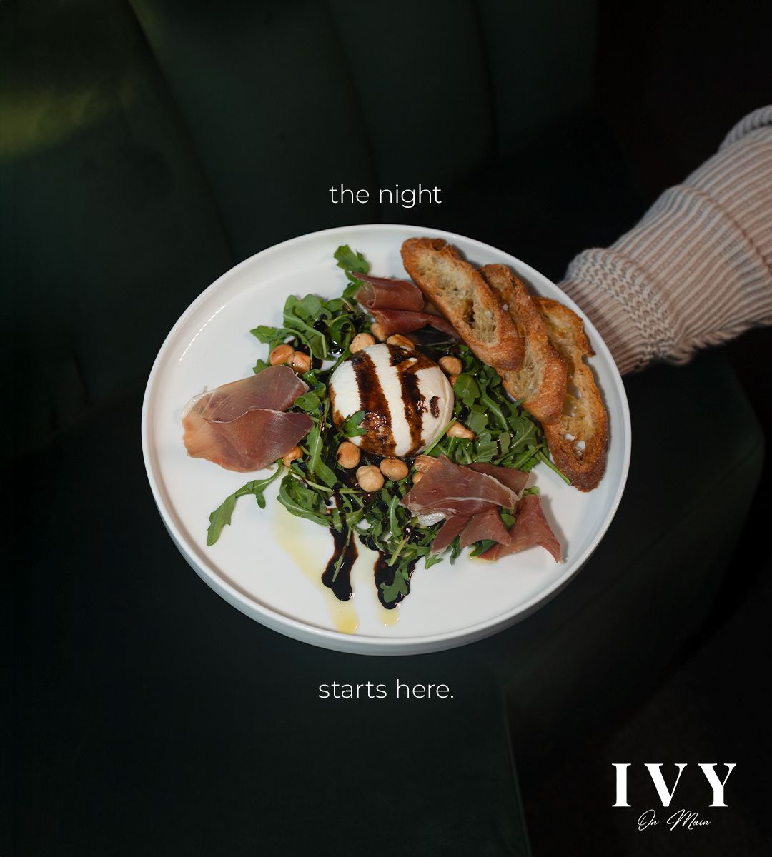plate of food with a hand holding it with text saying the night starts here.